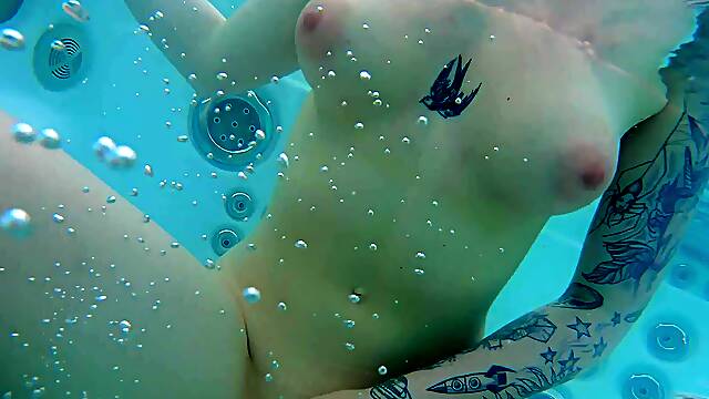 Barely legal brunette babe pleasures her shaven puss in the sun by the pool
