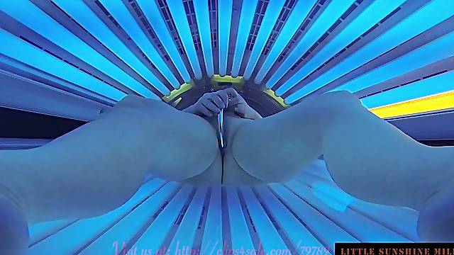 Lady with dildo in solarium