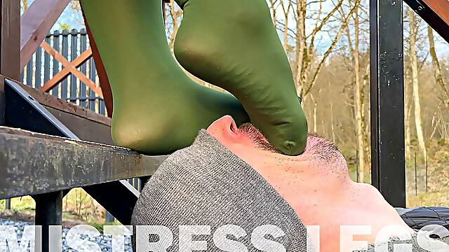 Gentle foot worship mistress feet in green pantyhose outdoor